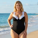 Woman wearing a black and white swimsuit on a beach